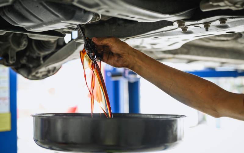 mechanic performing oil change at Brock Auto Centre Kamloops BC