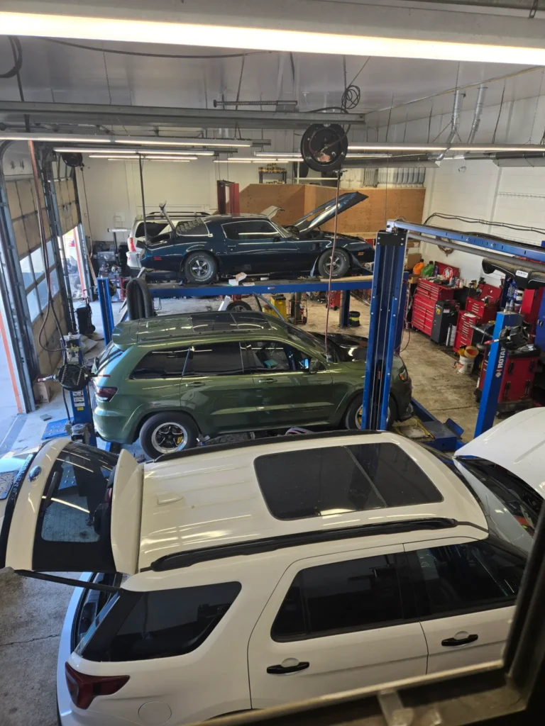 Multiple vehicles inside Brock Auto Centre’s repair shop in Kamloops, BC, for routine inspections and scheduled maintenance